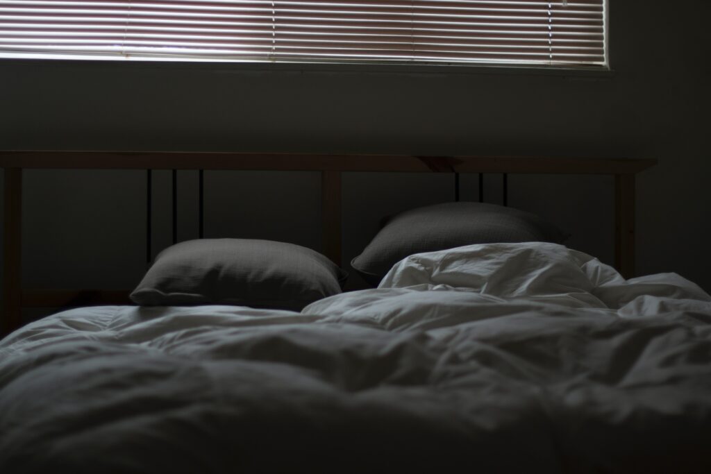 bed with two pillows in dark room #bettersleep